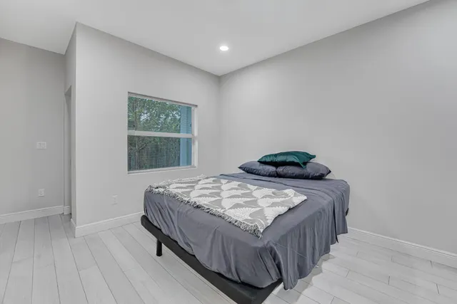 a bedroom with a bed and a window