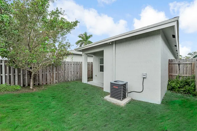 a backyard of a house with table and chairs