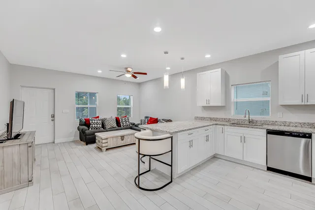 a very nice looking living room with a sink and a hard wood floor