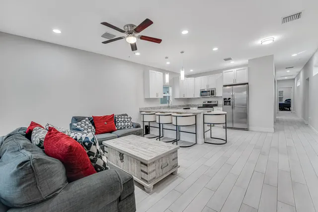 a living room with furniture and kitchen view