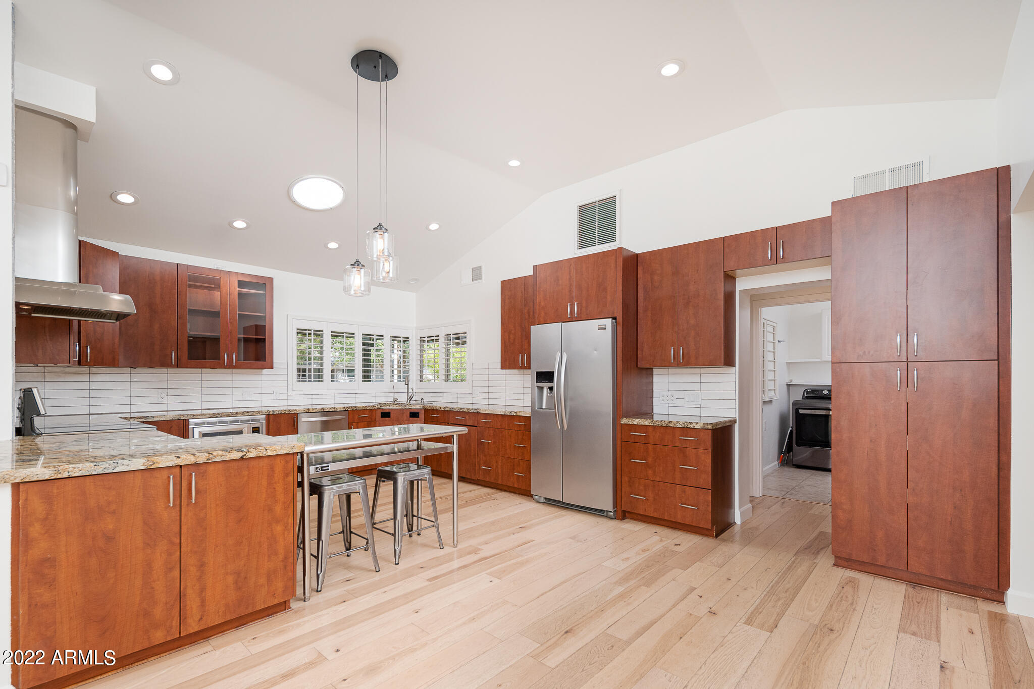 3864 North 50th Street Phoenix, AZ 85018 - Photo 13 of 15 a kitchen with stainless steel appliances granite countertop a refrigerator a sink dishwasher and a stove with wooden floor