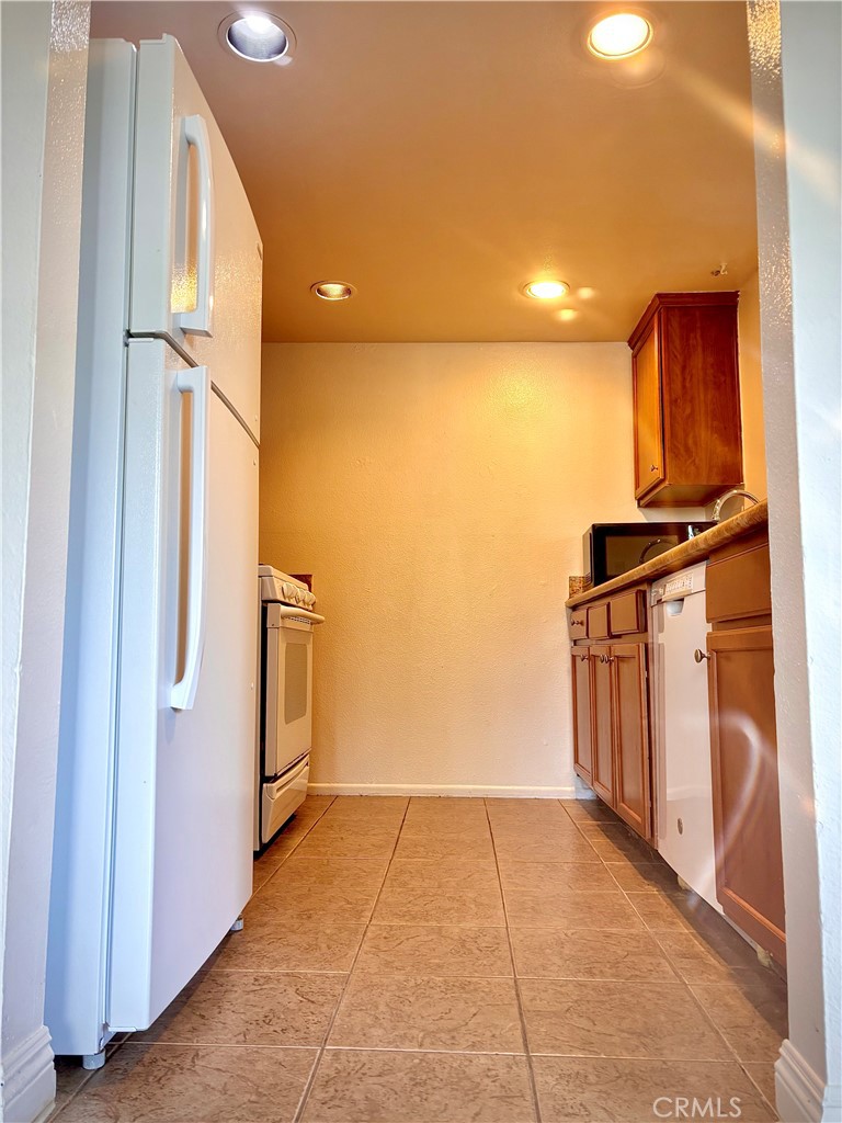 1110 West Blaine Street, Unit 102 Riverside, CA 92507 - Photo 12 of 25 a view of kitchen with furniture and refrigerator