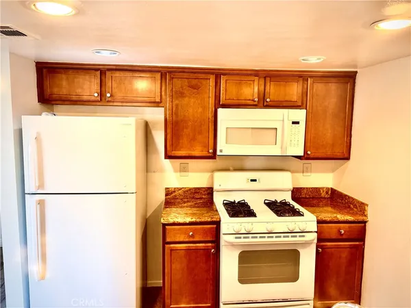 a kitchen with a refrigerator and a stove