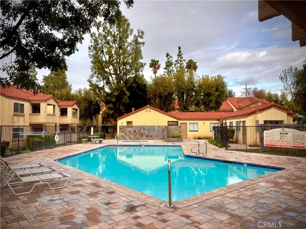 an outdoor space with swimming pool and furniture