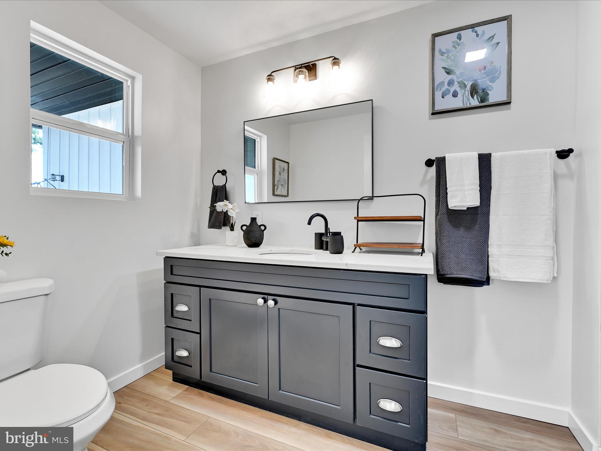 1056 West Leesport Road Leesport, PA 19533 - Photo 15 of 30 a bathroom with a toilet a sink and mirror