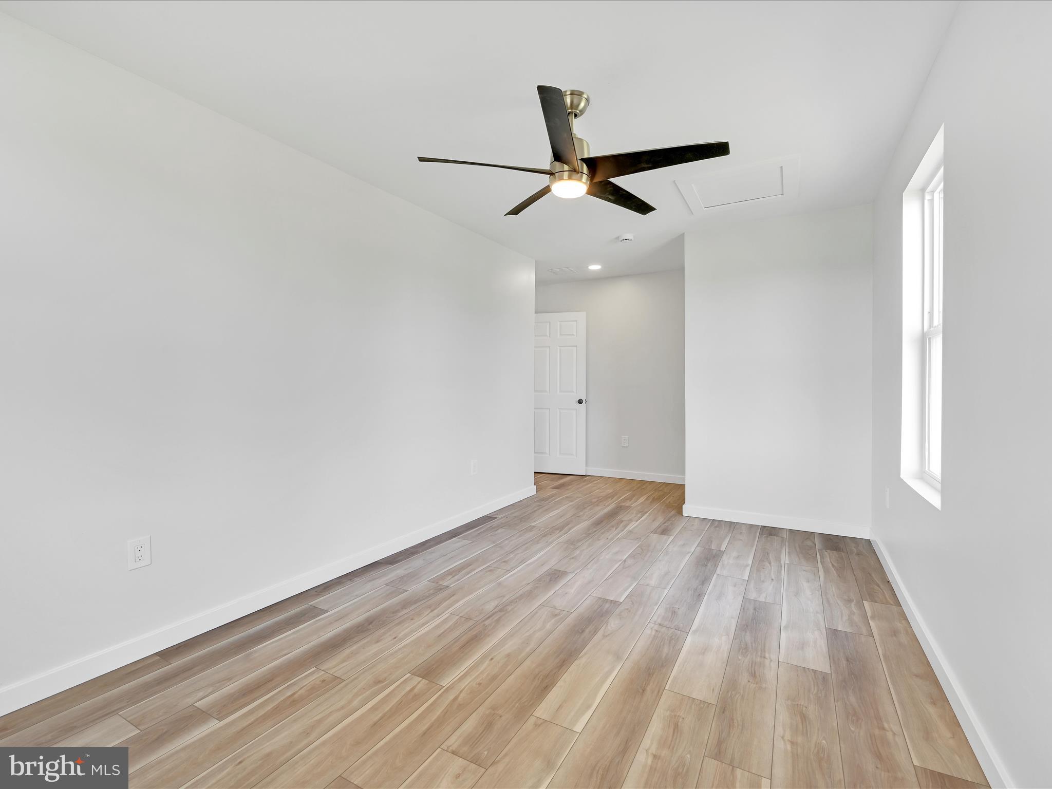 1056 West Leesport Road Leesport, PA 19533 - Photo 20 of 30 an empty room with wooden floor ceiling fan and windows