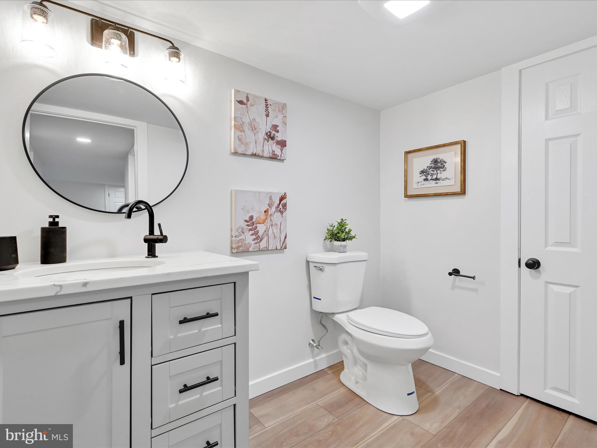 1056 West Leesport Road Leesport, PA 19533 - Photo 23 of 30 a bathroom with a toilet a sink and mirror