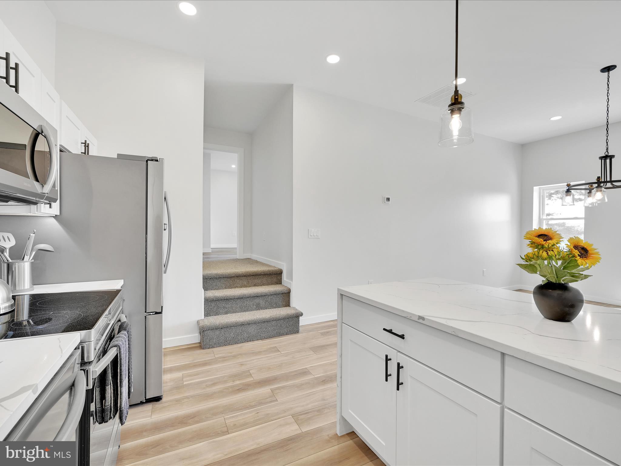 1056 West Leesport Road Leesport, PA 19533 - Photo 6 of 30 a kitchen with a refrigerator and white cabinets