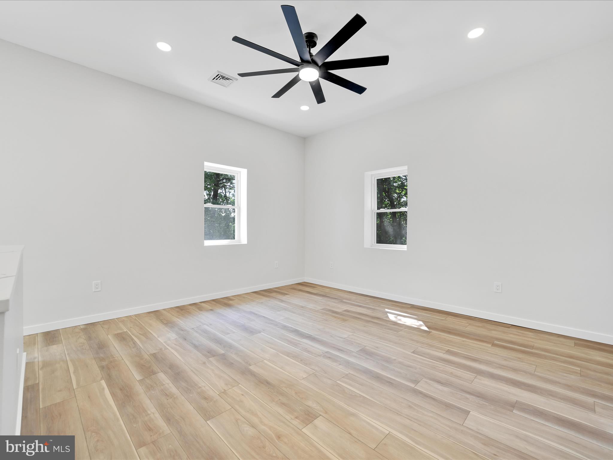 1056 West Leesport Road Leesport, PA 19533 - Photo 7 of 30 an empty room with wooden floor and a ceiling fan
