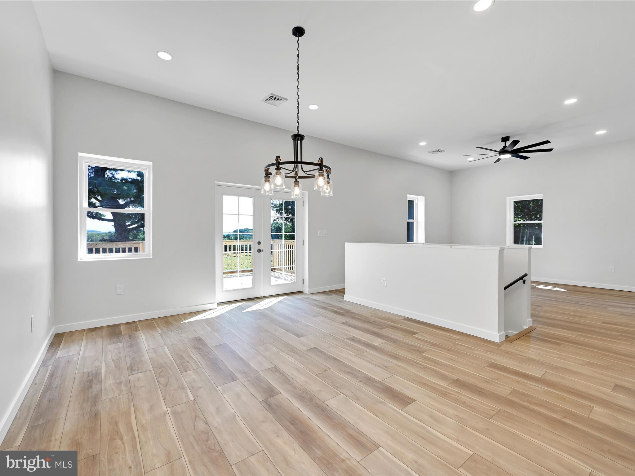 1056 West Leesport Road Leesport, PA 19533 - Photo 10 of 30 a view of a room with wooden floor a ceiling fan and windows