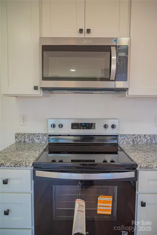 a stove top oven sitting inside of a kitchen