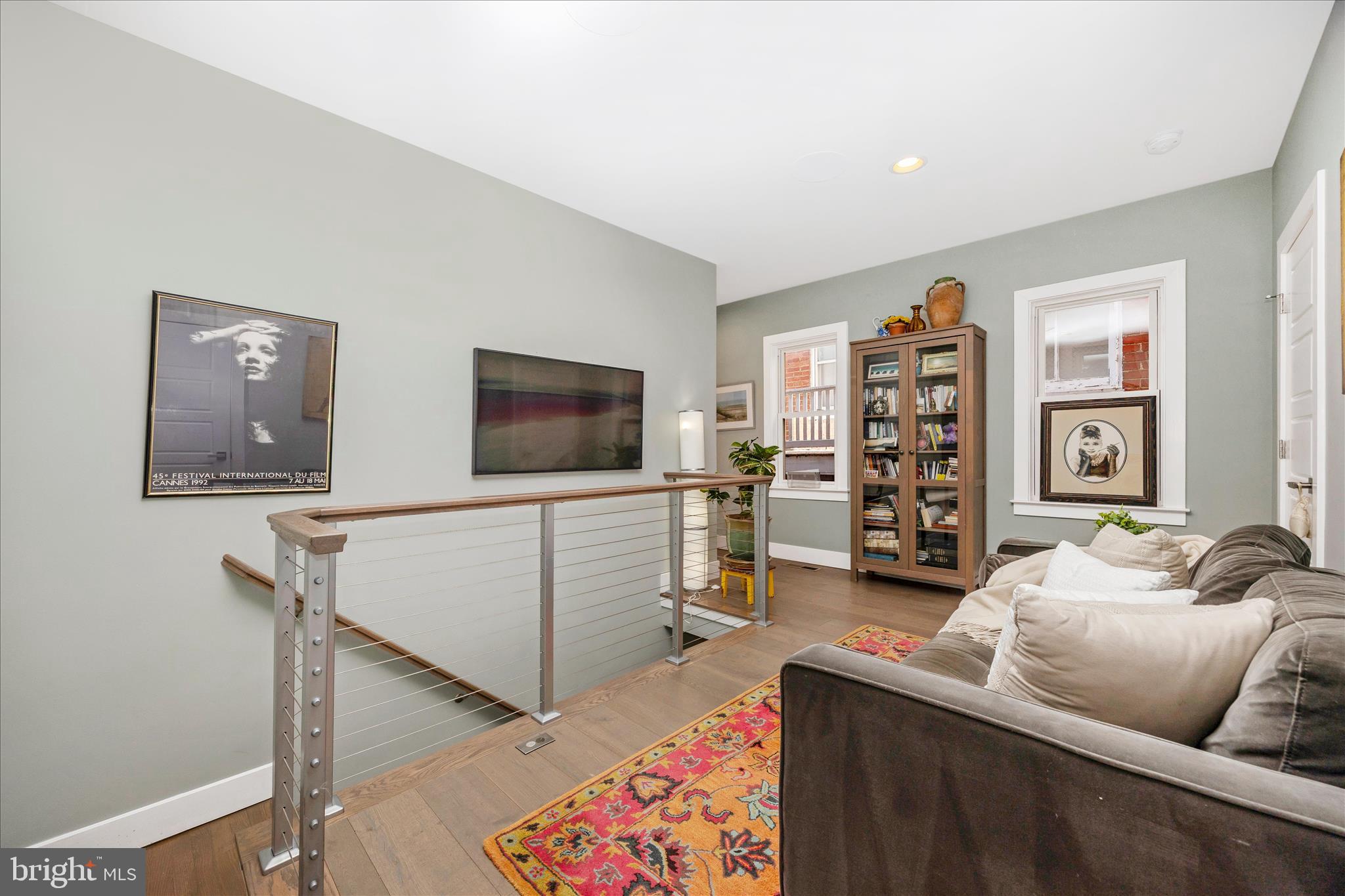 8 1/2 West 5th Street Frederick, MD 21701 - Photo 26 of 62 a living room with furniture and a flat screen tv