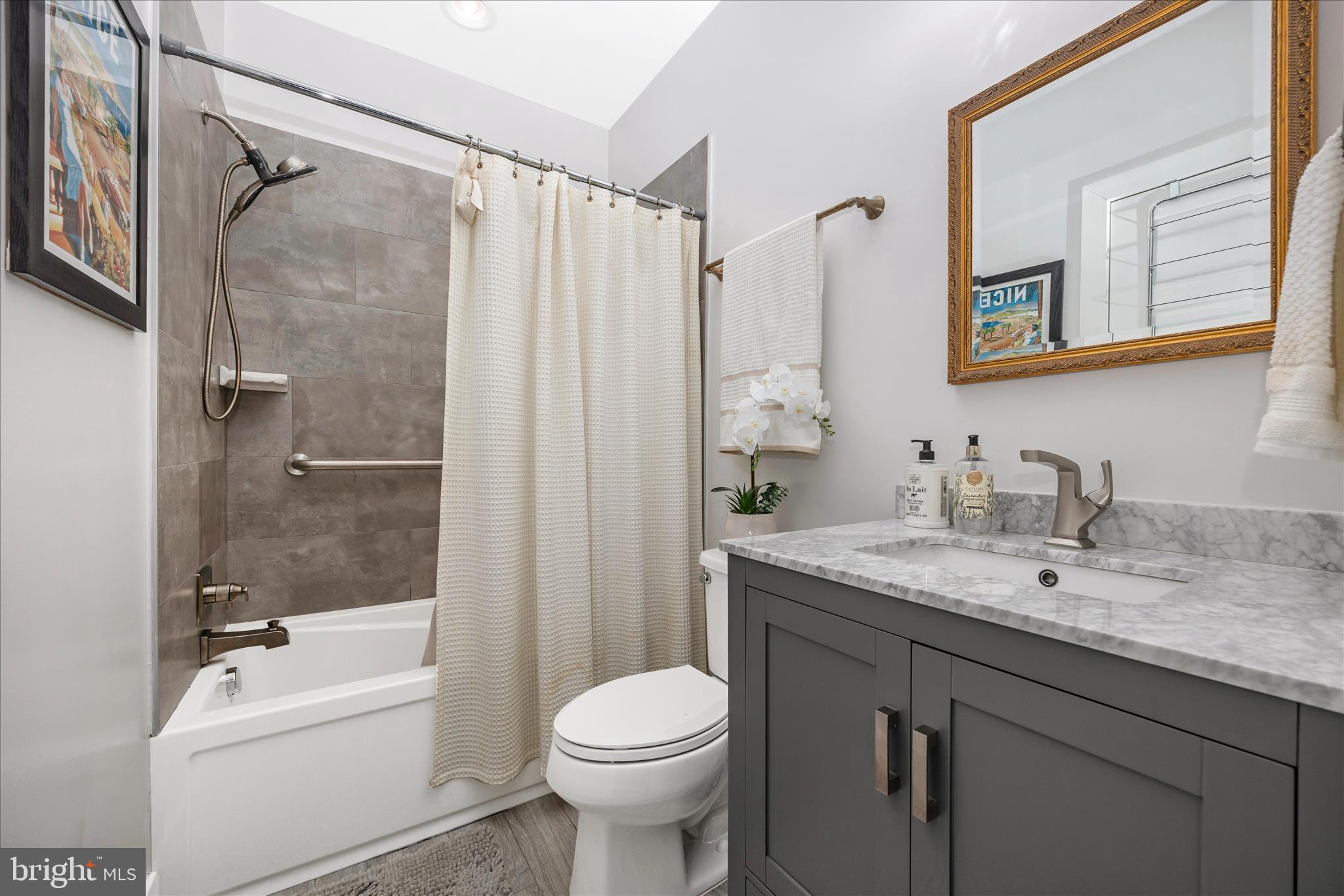 8 1/2 West 5th Street Frederick, MD 21701 - Photo 42 of 62 a bathroom with a granite countertop sink toilet and shower