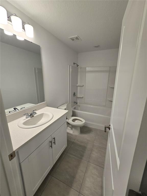 3575 Mayfair Street Kissimmee, FL 34758 - Photo 17 of 34 a bathroom with a sink a toilet and shower