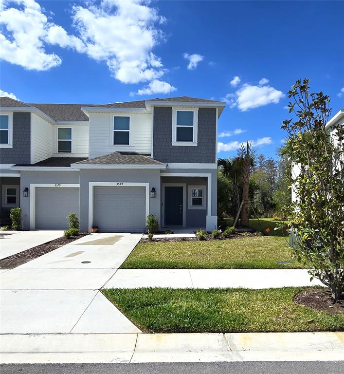 3575 Mayfair Street Kissimmee, FL 34758 - Photo 2 of 34 a front view of a house with a yard