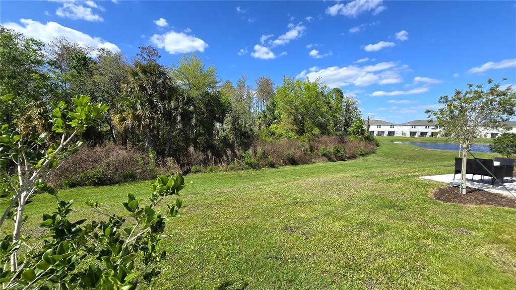 3575 Mayfair Street Kissimmee, FL 34758 - Photo 22 of 34 a backyard of a house with a yard and outdoor seating