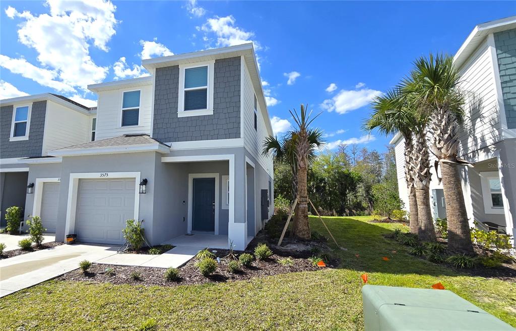 3575 Mayfair Street Kissimmee, FL 34758 - Photo 3 of 34 a view of a house with backyard and trees
