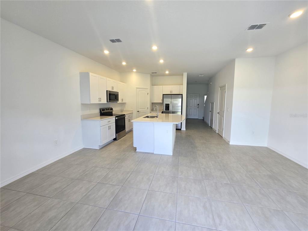 3575 Mayfair Street Kissimmee, FL 34758 - Photo 6 of 34 a view of a kitchen with a sink and cabinets