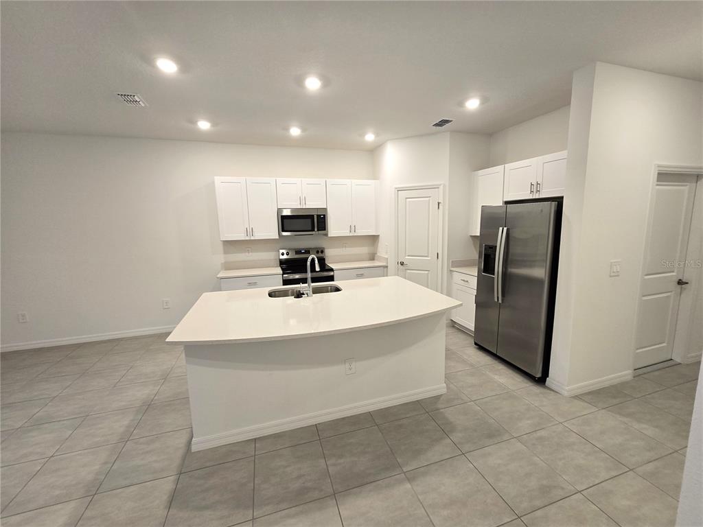 3575 Mayfair Street Kissimmee, FL 34758 - Photo 8 of 34 a view of kitchen with stainless steel appliances a refrigerator and a sink