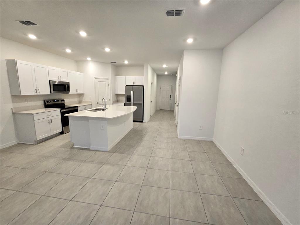 3575 Mayfair Street Kissimmee, FL 34758 - Photo 10 of 34 a view of a kitchen with microwave and cabinets