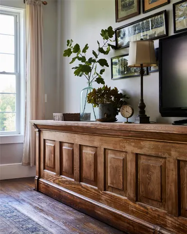 a kitchen with a refrigerator and potted plant