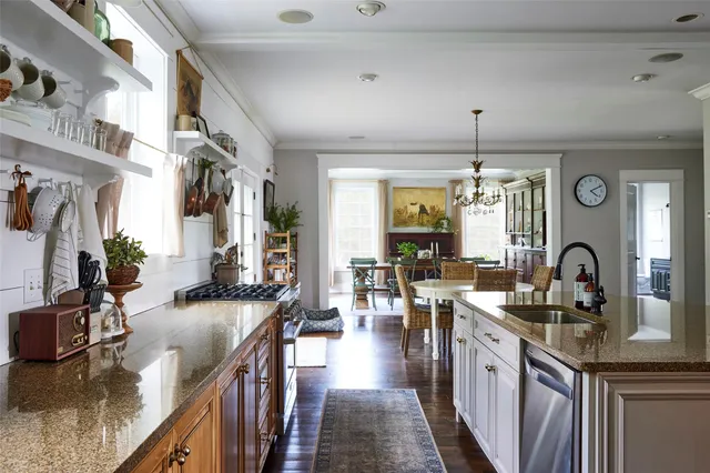 a kitchen with counter top space and wooden floor