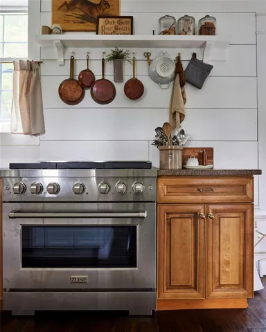 a stove top oven sitting inside of a kitchen
