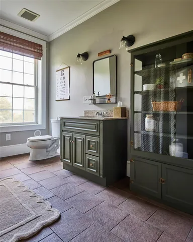 a view of a hallway to a livingroom with furniture