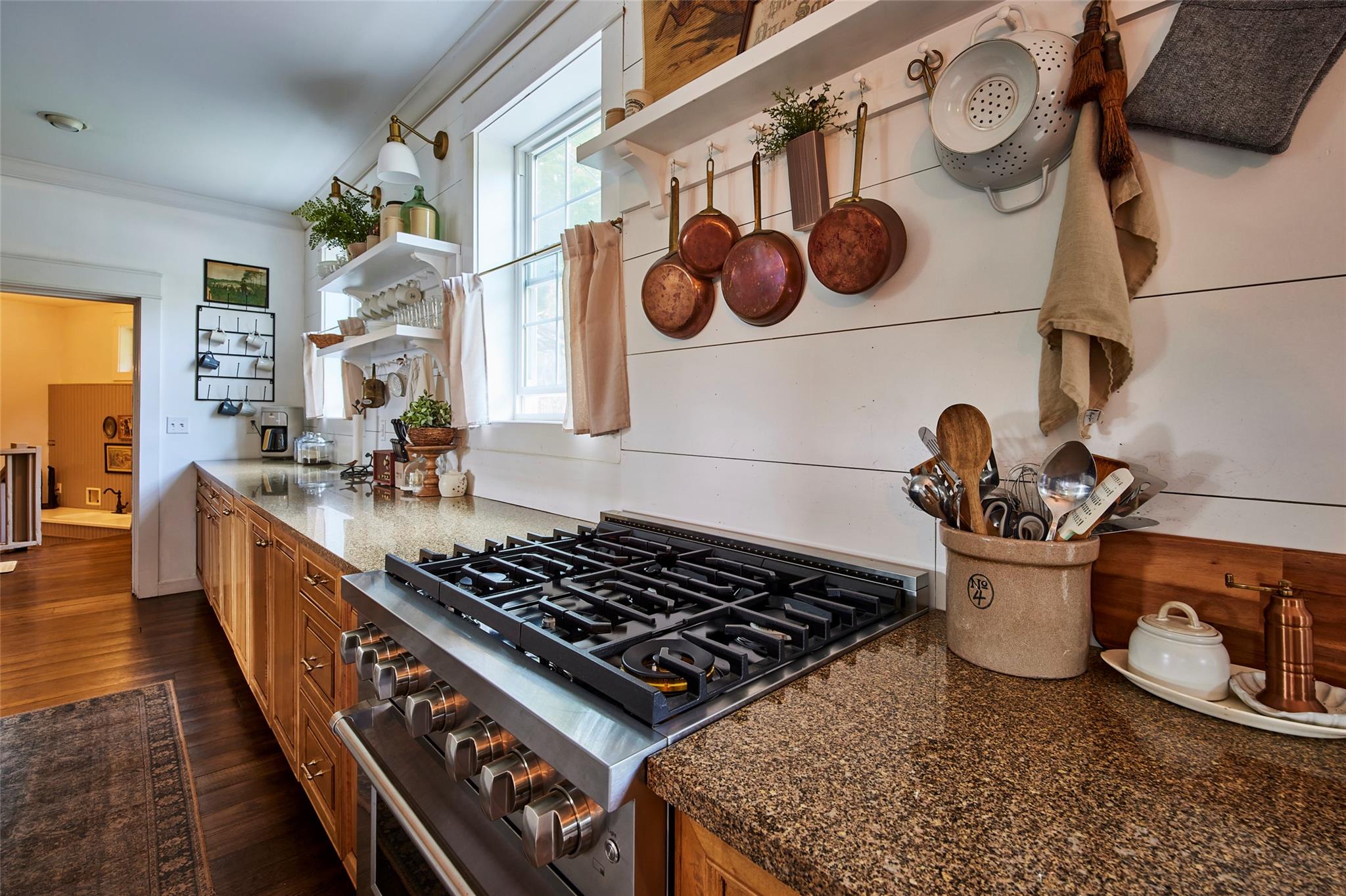 382 Benton Hollow Road Neversink, NY 12765 - Photo 20 of 50 a kitchen with a stove and a wooden floor