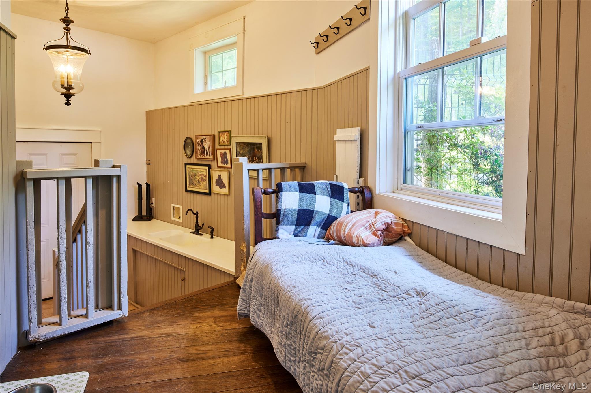 382 Benton Hollow Road Neversink, NY 12765 - Photo 22 of 48 Bedroom with dark wood-type flooring, multiple windows, and wood walls