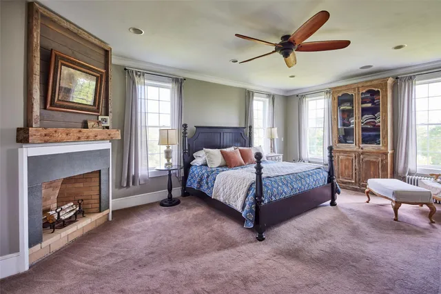 a bedroom with a large bed and a chandelier