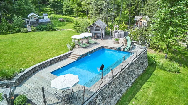 a view of a backyard with table and chairs and potted plants