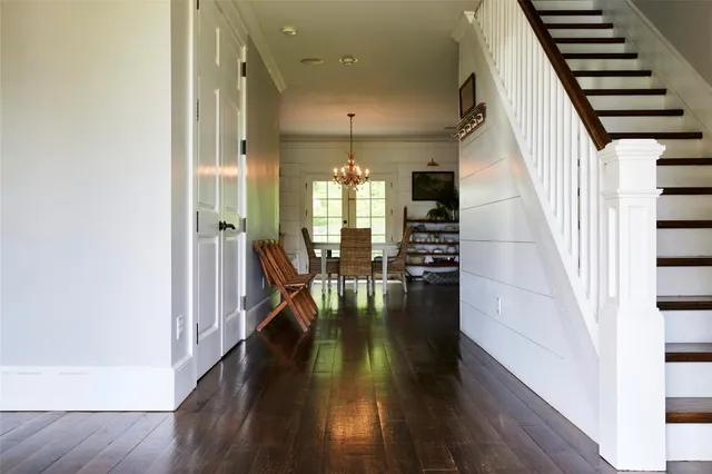 a view of entryway and hall with wooden floor