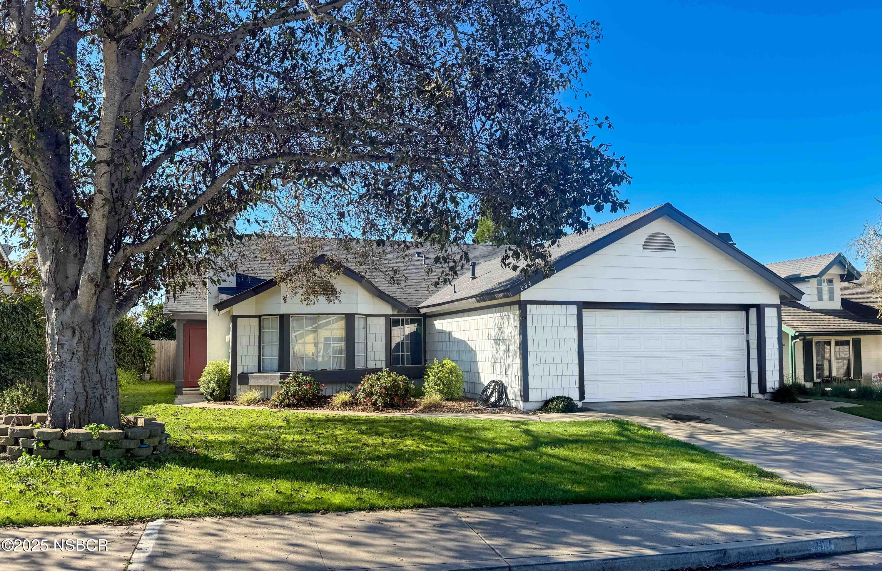a front view of a house with a yard and garage