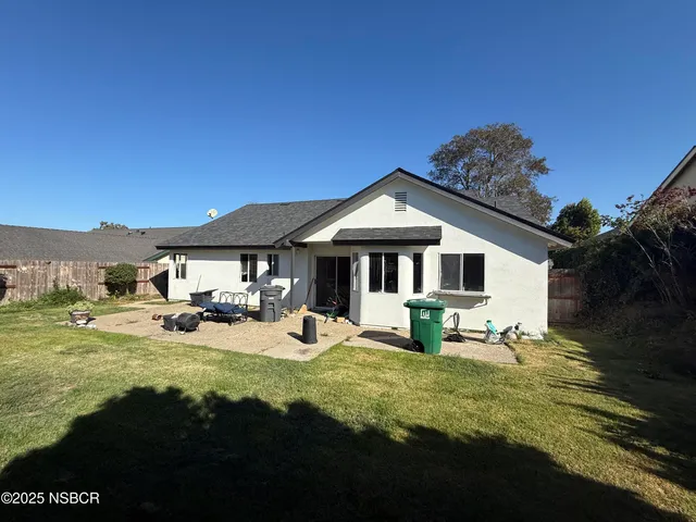 a view of a house with swimming pool and sitting area
