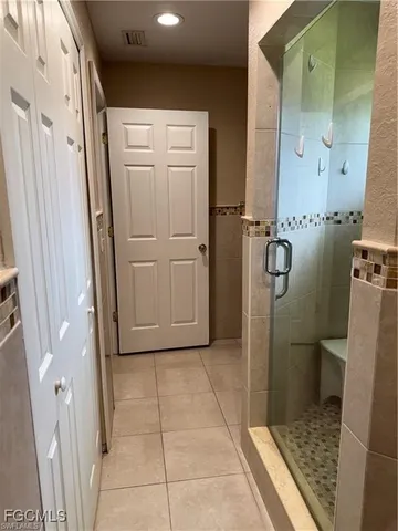 a bathroom with a glass door shower and a sink