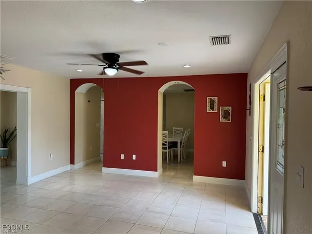 a view of an empty room with a ceiling fan