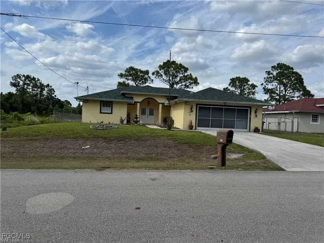 a front view of a house with a garden