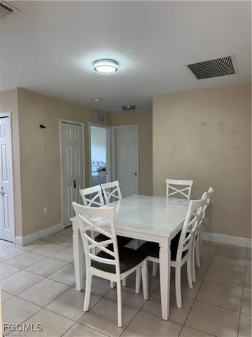 a view of a dining room that has a table and chairs in it