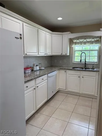 a kitchen with a stove sink and cabinets