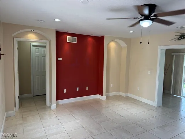 a view of a livingroom with a chandelier fan and a bathroom