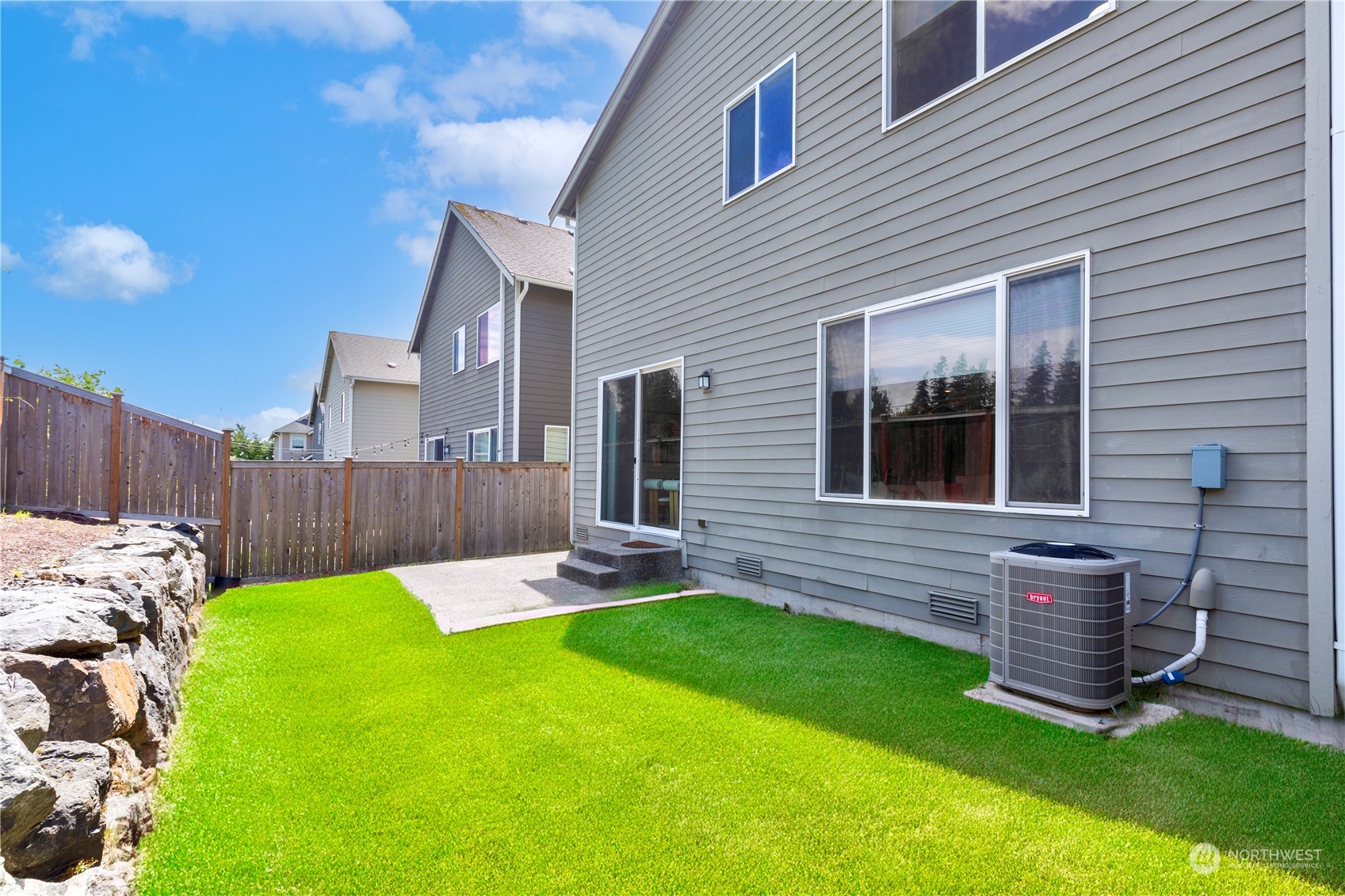 21311 42nd Avenue Southeast Bothell, WA 98021 - Photo 21 of 24 a view of a backyard with table and chairs and wooden fence