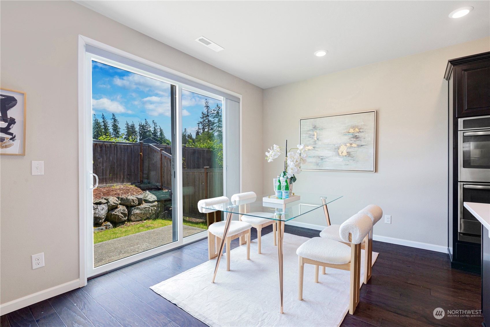 21311 42nd Avenue Southeast Bothell, WA 98021 - Photo 7 of 24 a view of a dining room with furniture wooden floor and a floor to ceiling window