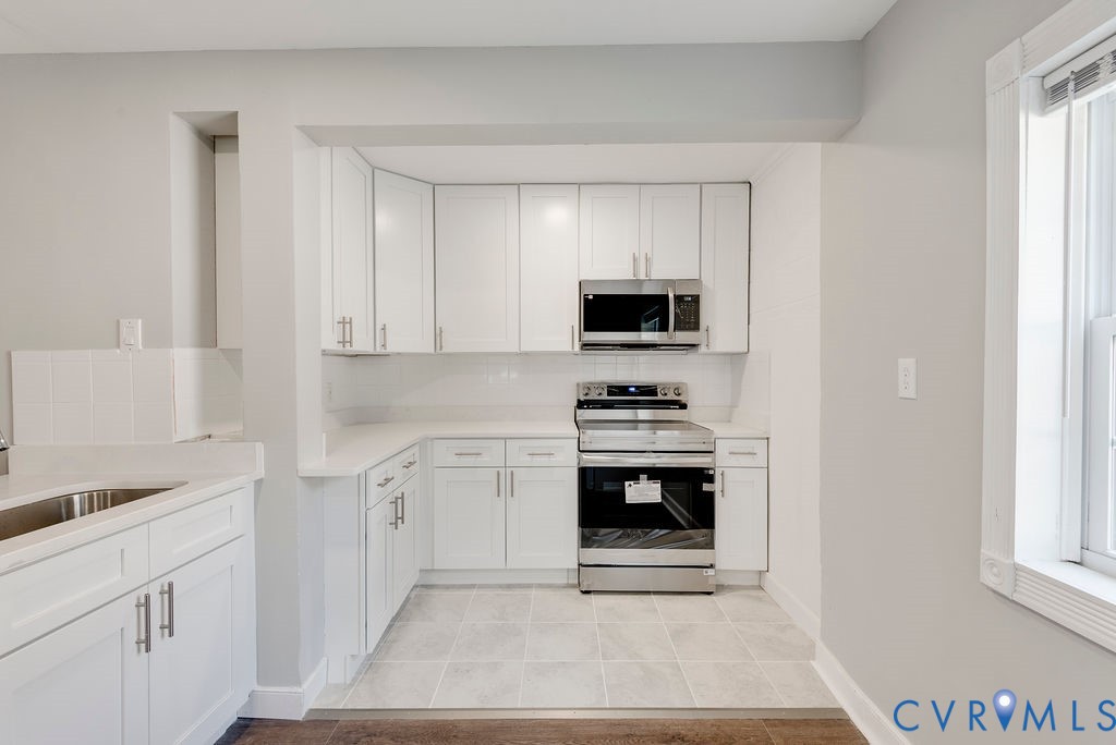 8510 Hunton Circle North Chesterfield, VA 23235 - Photo 18 of 32 a kitchen with white cabinets and appliances