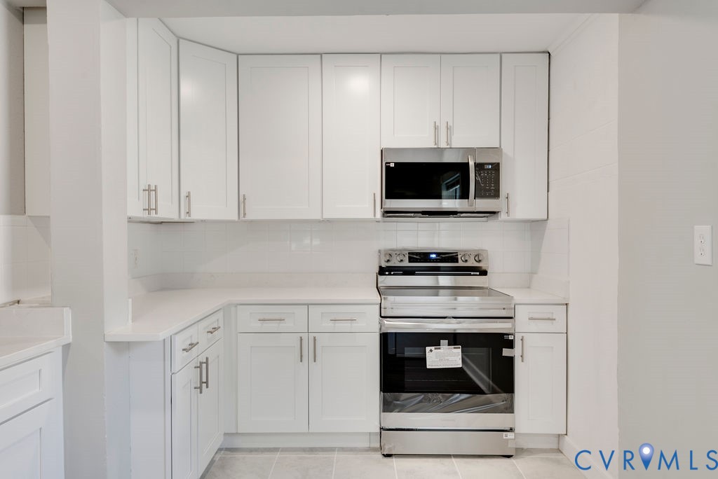 8510 Hunton Circle North Chesterfield, VA 23235 - Photo 19 of 32 a kitchen with white cabinets and stainless steel appliances