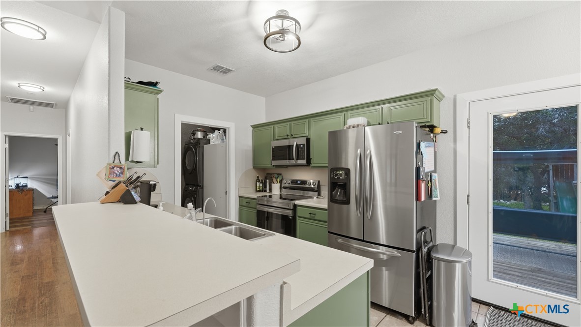 2216 Hornsby Spring Branch, TX 78070 - Photo 11 of 33 a large kitchen with a refrigerator a stove and a sink