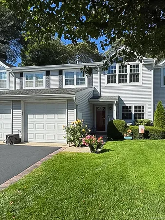 a front view of a house with a garden and yard
