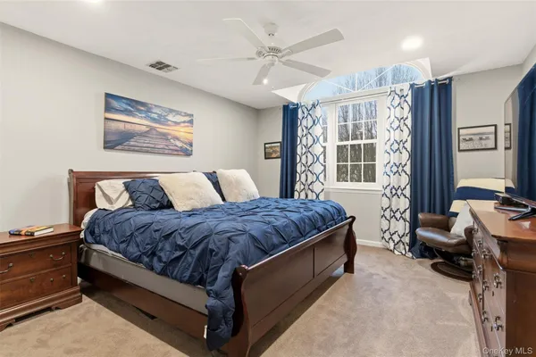 a spacious bedroom with a bed and a desk