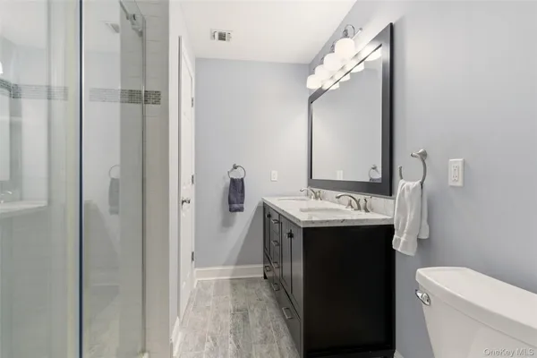 a bathroom with a sink toilet and shower