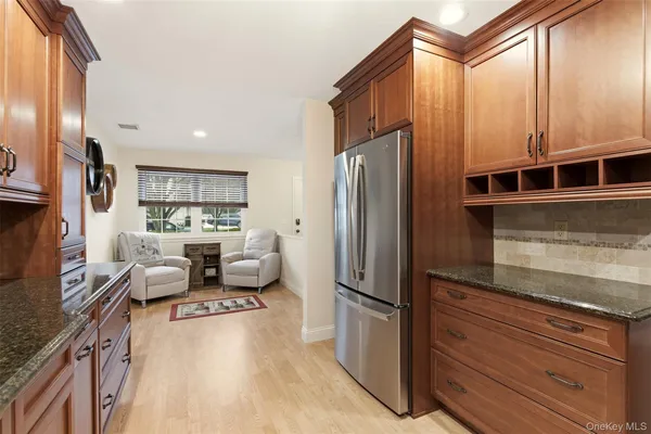 a kitchen with stainless steel appliances granite countertop a refrigerator and a stove